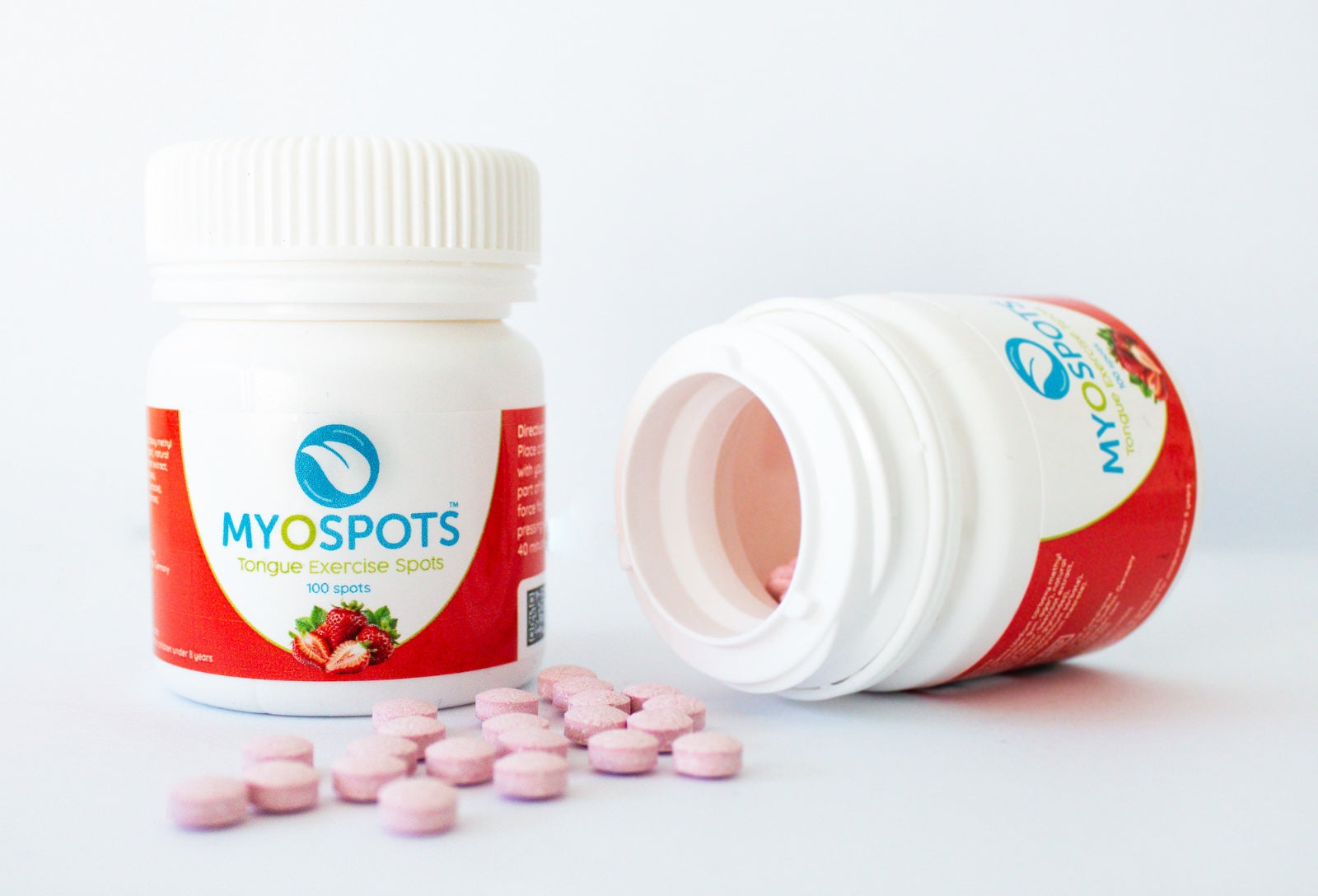 MYOSPOTS tongue exercise spot bottle with pink capsules on a white background