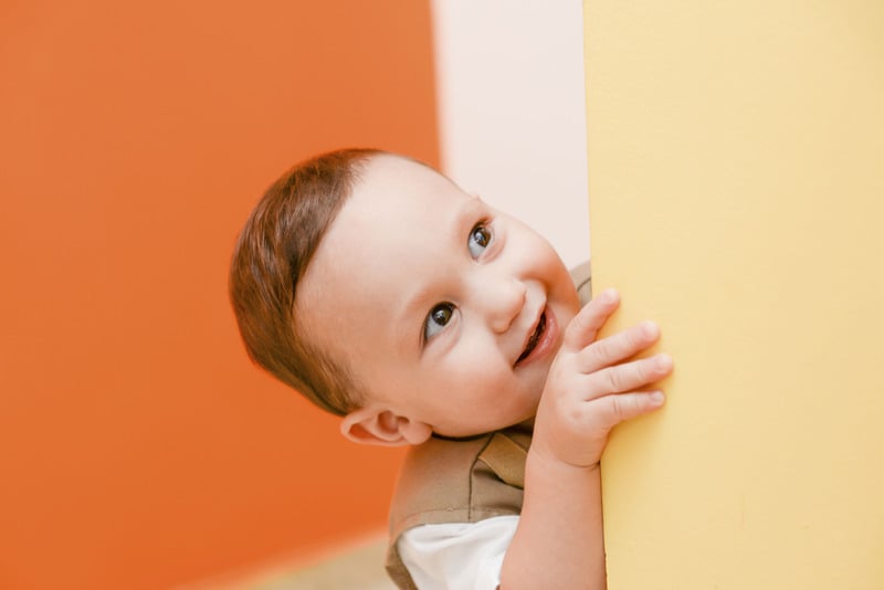 Cute kid poking head around a corner